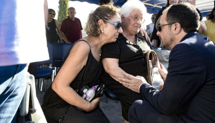 Cypriot President Nikos Christodoulides (right) talks with the widow of a soldier killed in the 1974 Turkish invasion of Cyprus, at Makedonitissa military cemetery in Nicosia. — AFP/file