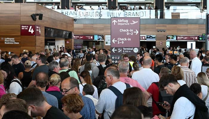 Passengers are seen queueing for departures at the BER Berlin-Brandenburg Airport in Schoenefeld, southeast of the German capital, on July 19, 2024. —AFP