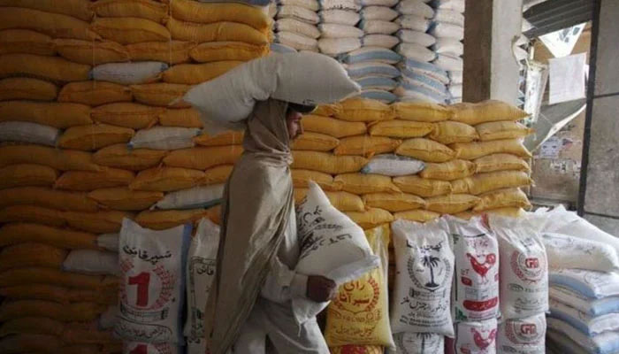 A representational image of a man carrying bags of flour. — Reuters/file