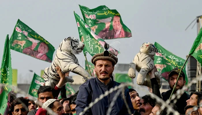 Supporters of Pakistan Muslim League Nawaz wave flags at Mansehra in Khyber Pakhtunkhwa province on January 22, 2024. — AFP