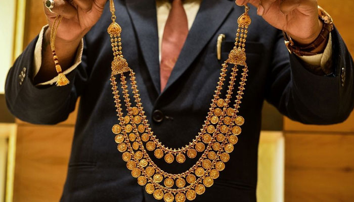 A man showing a gold necklace in this image. — AFP/file