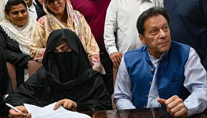 PTI founder Imran Khan (right) and his wife, Bushra Bibi (left) ahead of a court hearing. — AFP/file