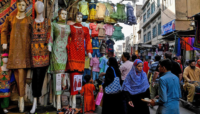 Shoppers crowd at a market area in Lahore, Pakistan on March 31, 2024. — AFP