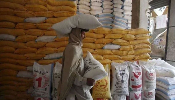 A representational image of a man carrying bags of flour. — Reuters/file