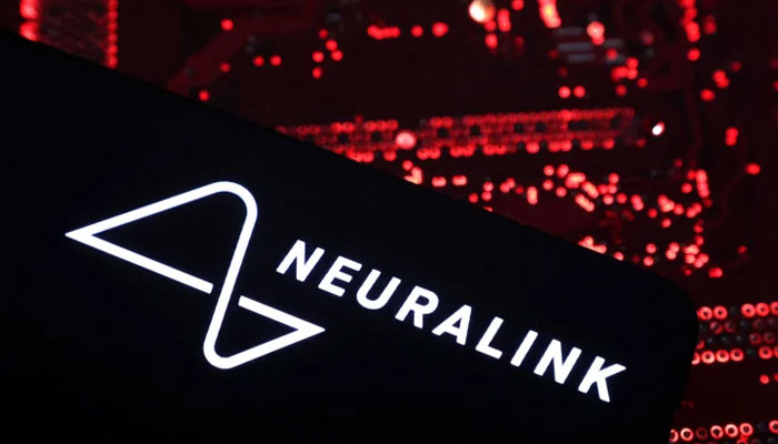 A smartphone with a Neuralink logo displayed is placed on a computer motherboard in this image on May 15, 2024. — Reuters