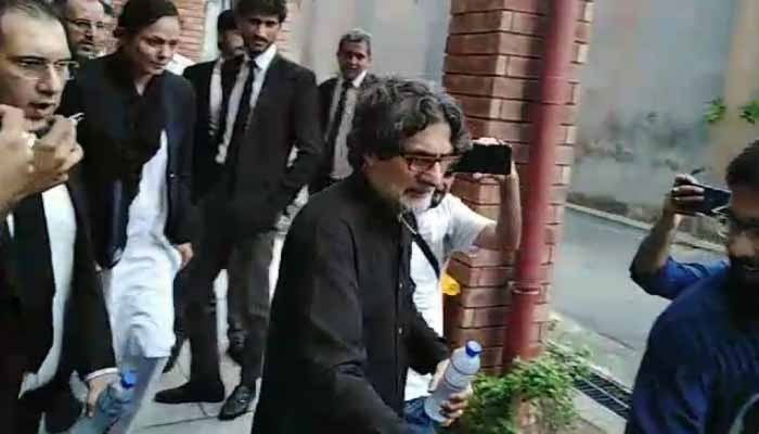 PTI Information Secretary Raoof Hasan walks as he is presented before a court for a hearing in Islamabad on July 23, 2024. — Geo News