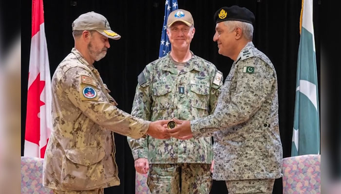 Commodore Asim Sohail Malik of the Pakistan Navy (right) assumes command from Captain Mathews of the Royal Canadian Navy (left) during an impressive change of command ceremony at the Headquarters of US NAVCENT in Bahrain on July 23, 2024. — Facebook/Director General Public Relations - Navy