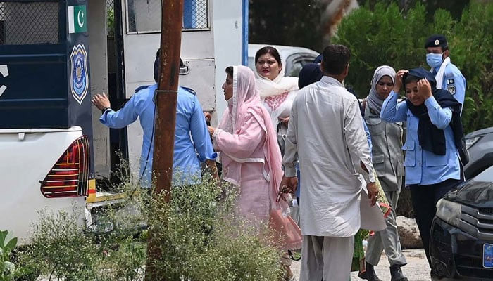 Women police officers taking the arrested female workers of the Pakistan Tehreek-e-Insaf (PTI) from the partys headquarters into police van after a security raid in Islamabad on July 22, 2024. — AFP