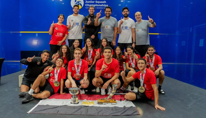 Egyptian male & female squash players celebrating with trophies of WSF World Junior Team Championship. — world squash website/file