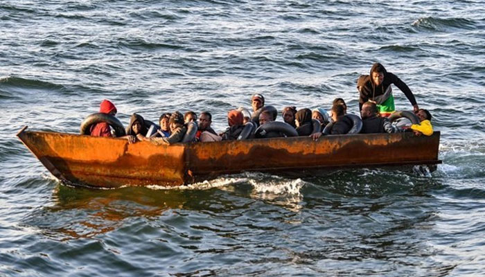 A small boat full of migrants can be seen in this image. — AFP/file