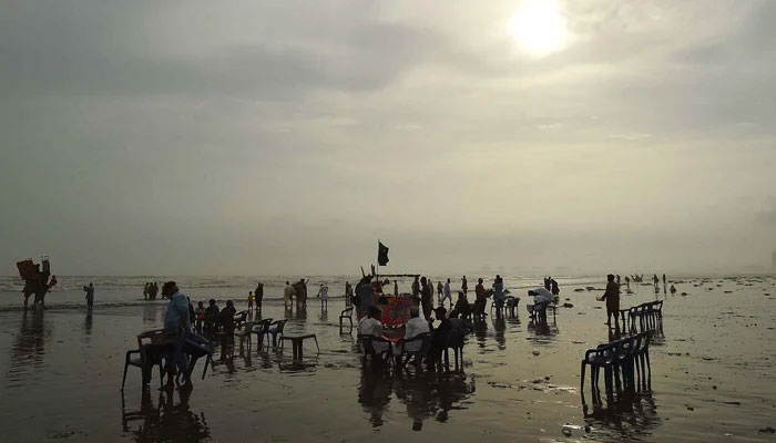 People seen at Karachis sea view on June 16, 2023. — INP