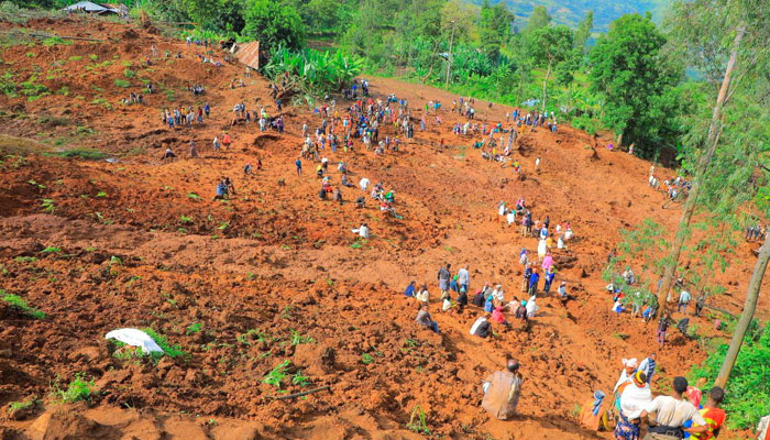 Residents dig to recover the dead bodies of victims of the landslide following heavy rains that buried people in Gofa zone, Southern Ethiopia July 23, 2024. — Reuters