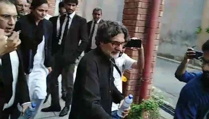 PTI Information Secretary Raoof Hasan walks as he is presented before a court for a hearing in Islamabad on July 23, 2024. — Geo News