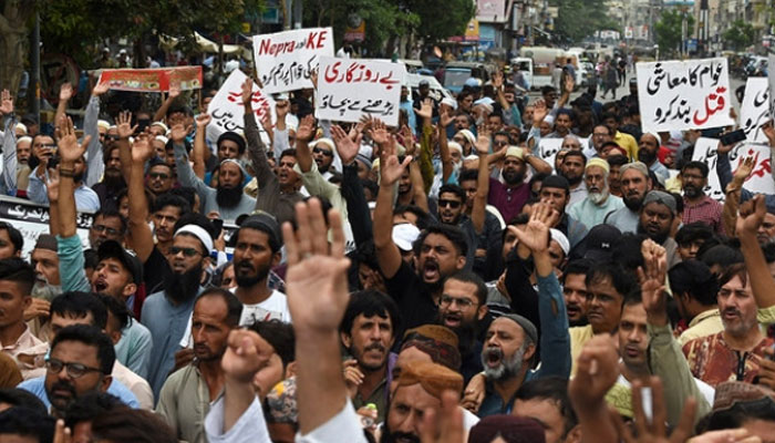 In this undated representational image, traders shout slogans against the surge in petrol and electricity prices during a protest at a street in Karachi. — AFP/File