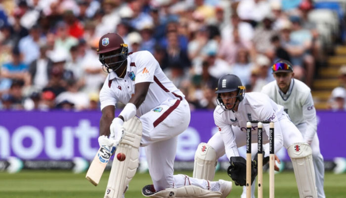 West Indies cricketer Jason Holder (left) plays a shot during their Test match against England.  — AFP/File