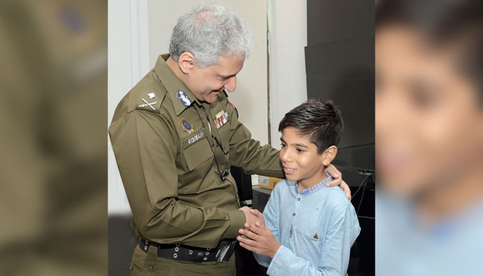 Inspector General of Police Punjab Dr Usman Anwar shakes hands with a child at the Central Police Office on July 25, 2024. — Facebook/Punjab Police Pakistan