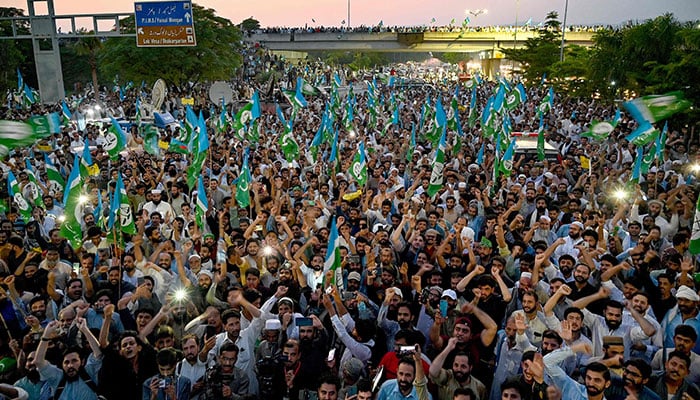 Activists and supporters of Jamaat-e-Islami (JI) shout slogans and wave their party flag to protest against rising inflation in Islamabad on July 26, 2024. — AFP