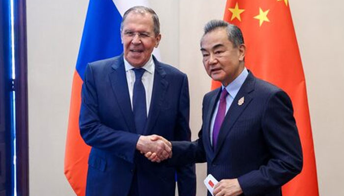 Russian Foreign Minister Sergei Lavrov (left) and Chinese Foreign Minister Wang Yi shake hands as they meet in Denpasar, Indonesia July 7, 2022. — Reuters