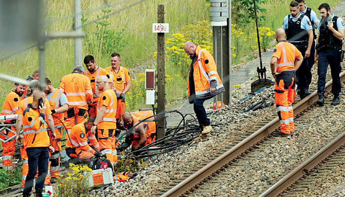 SNCF employees and French security officials inspect the scene of a suspected sabotage on the high speed railway network at Croiselles, northern France. — AFP/file