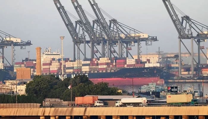 Shipping containers are seen stacked on a ship at a sea port in Karachi. — AFP/File