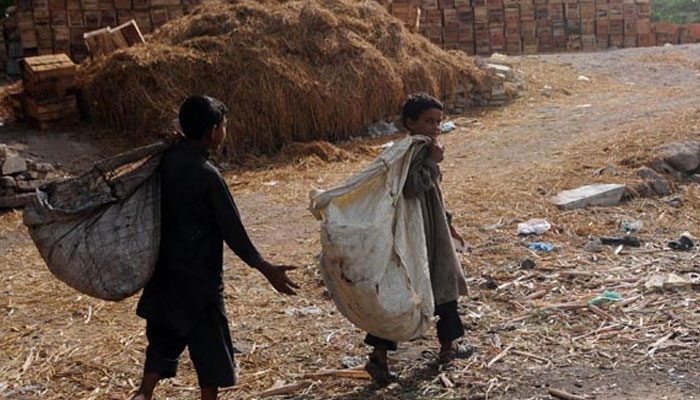 Children search for recyclable items at a garbage dump in Pakistan. — AFP/File