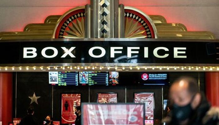 A guest purchases a ticket in front of a box office at AMC movie theatre in Lincoln Square in the Manhattan borough of New York City, New York, US on March 6, 2021. — Reuters