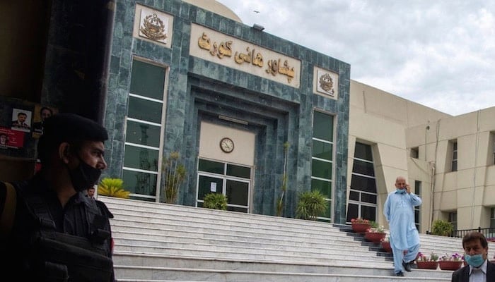 A lawyer walks past in front of the Peshawar High Court building. — AFP/File