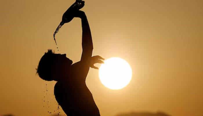 A runner cools down with water in Skopje, North Macedonia July 12, 2023. — Reuters