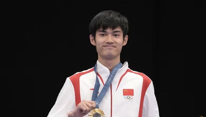 Gold medallist Lihao Sheng of China poses with his medal on July 29, 2024. — Reuters