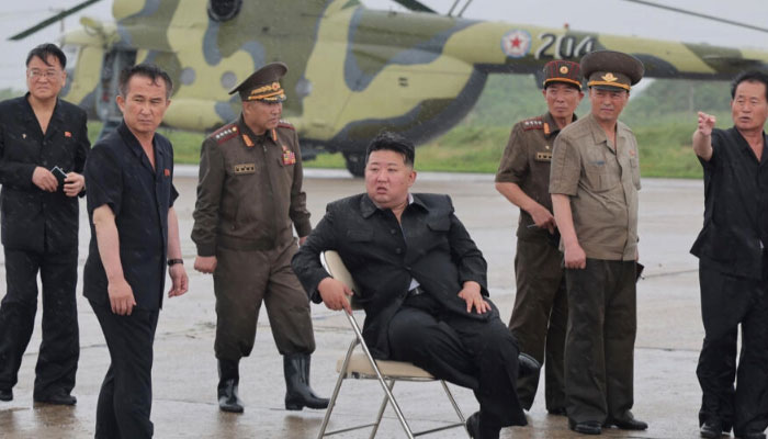 A handout picture from North Koreas official Korean Central News Agency shows leader Kim Jong Un (seated) inspecting helicopter flood rescue operations in Sinuiju. — AFP