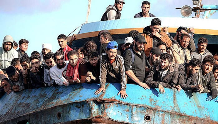 This representational image shows people on a boat travelling by sea from their respective countries. — AFP/File