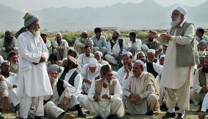 A representational image of shows members of bajaur Jirga sitting while an elder speaks. — AFP/File