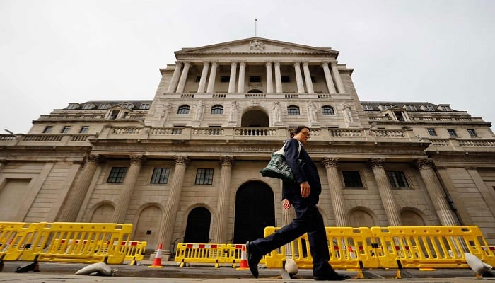 A pedestrian walks past the Bank of England in London. — AFP/File