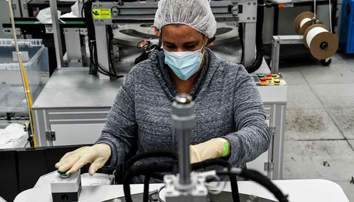 An employee makes respiratory masks in a family-owned medical equipment factory in Miami, USA. — AFP/File