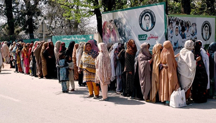 A large number of women stand in a queue to draw money from Benazir Income Support Programme (BISP) beneficiaries outside Benazir One Window Centre. — APP/File