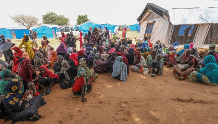 Women who fled the war in Sudan await the distribution of international aid rations at the Ourang refugee camp, near Adre town in eastern Chad. — AFP/File