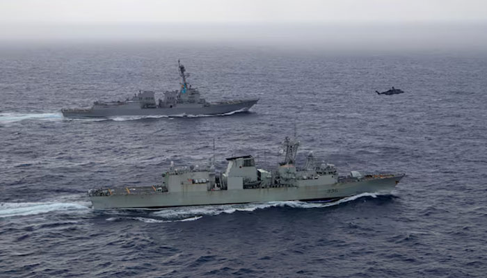 U.S. Navy guided-missile destroyer USS Chung-Hoon sails alongside the Royal Canadian Navy frigate HMCS Montreal during Surface Action Group operations as a part of exercise “Noble Wolverine in the South China Sea  on May 30, 2023. — Reuters