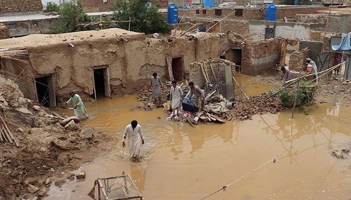 Residents clear debris of a damaged house due to a heavy monsoon rainfall on July 5, 2022. — AFP