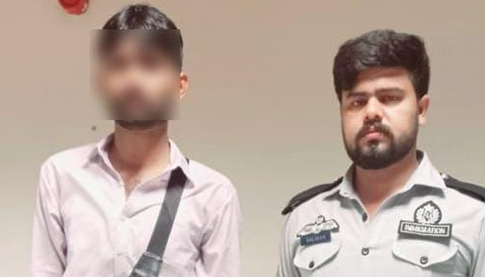 Suspect Haseeb (left) pictured alongside a security official after being arrested in this image released on August 2, 2024 — Facebook @FIAAgencyOfficial