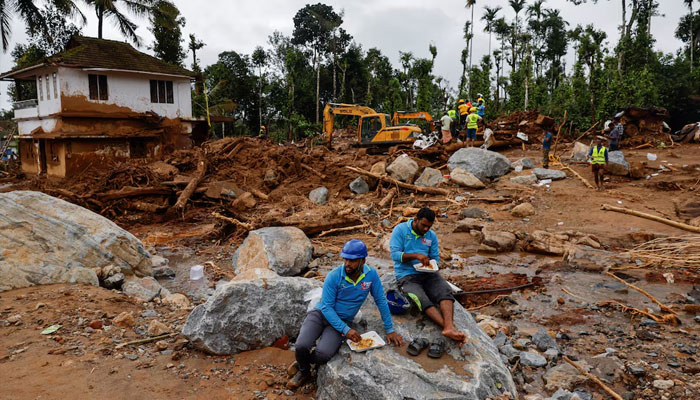 Volunteers eat food as rescue operations continue after multiple landslides hit the hills in Wayanad district, in the southern state of Kerala, India, July 31, 2024. — Reuters