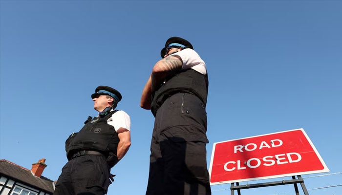 Police officers stand near a Road closed sign, on the junction of Tithebarn Road and Hart Street, near the scene where a teenage suspect was arrested after people were stabbed in Southport, Britain, August 1, 2024. — Reuters