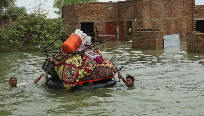 A representational showing residents move their belongings from their submerged houses after heavy monsoon rainfall in the flood affected area of Rajanpur district in Punjab on August 24, 2022. — AFP