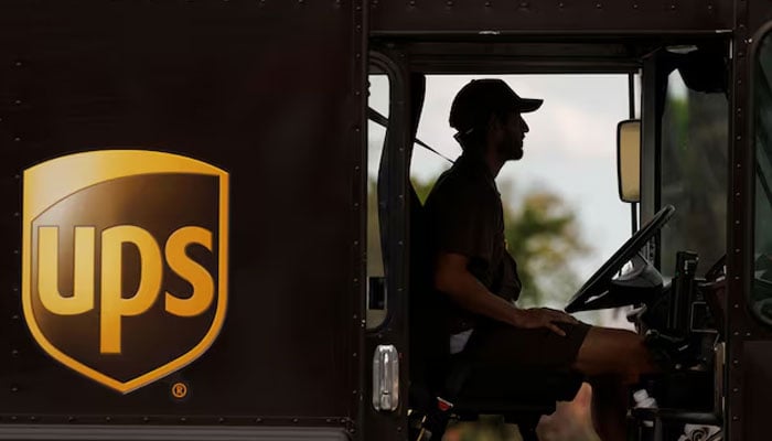 A man drives a  UPS delivery van along a city street in Garden Grove, California, U.S. Rueters/File