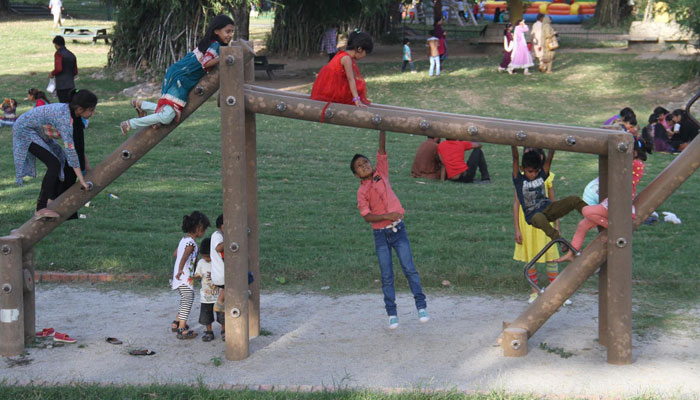 This undated photo shows children enjoy swings at a park during Eidul Azha celebrations in Islamabad. — INP/File