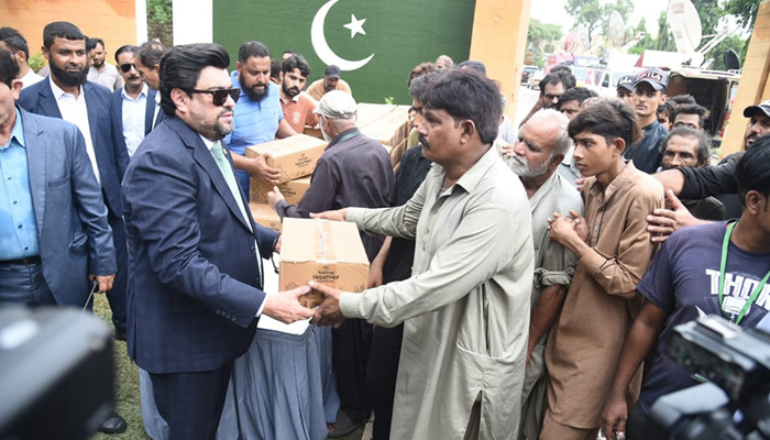 Sindh Governor Kamran Tessori is distributing ration to  people at Karachis Governor House on August 3, 2024. — Facebook @TeamKTessori