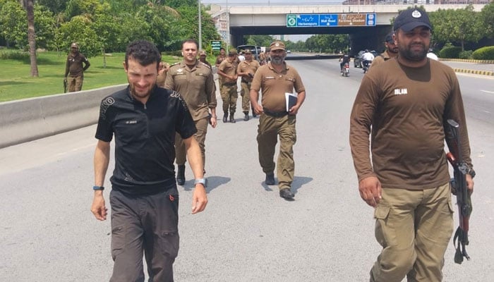 German tourist Berg Florian walking with police officials. — Geo News/Mian Abid/File