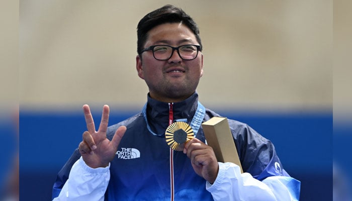 Gold medalist from South Korea Kim Woojin poses on the podium during medal ceremony for the archery mens individual round at the Paris 2024 Olympic Games in Paris on August 4, 2024. — AFP