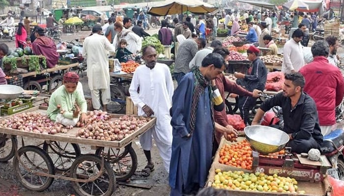 Vendors are selling vegetables at a market in Lahore on March 26, 2023. — Online