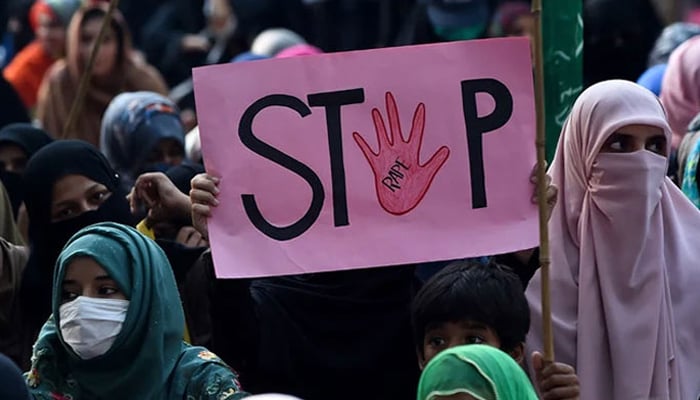 A woman holds a placard reading stop rape during a protest against alleged gang rape of a woman on September 17, 2020. — AFP/File