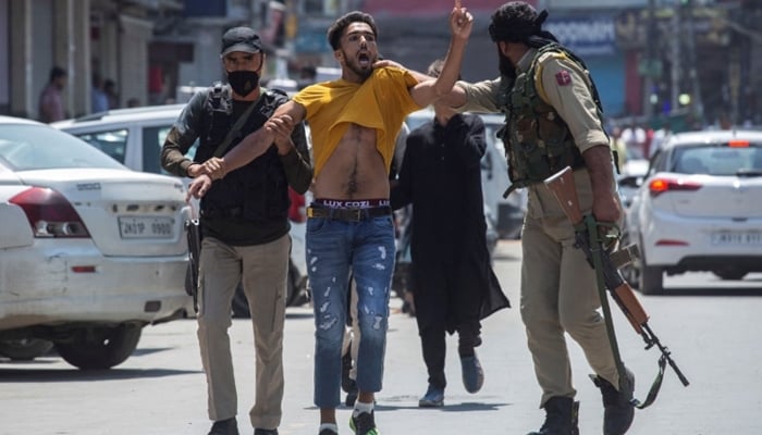 Indian policemen detain a Kashmiri youth in Srinagar, Indian Illegally Occupied Jammu and Kashmir (IIOJ&K). — AFP/File